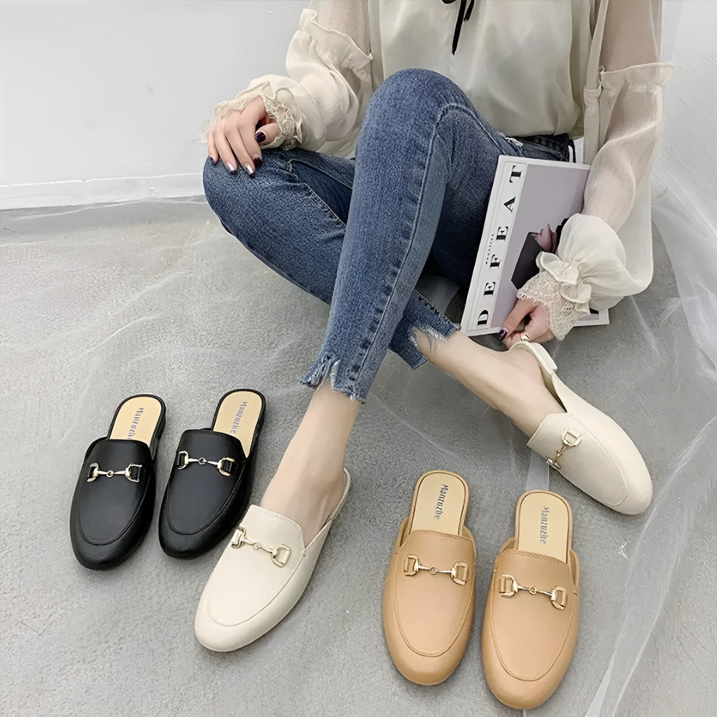 Women's PVC closed toe half slipper with metal buckle fastening in milky white.