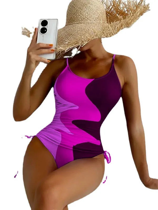 Women's blue sleeveless backless one-piece swimsuit with striped pattern on a mannequin