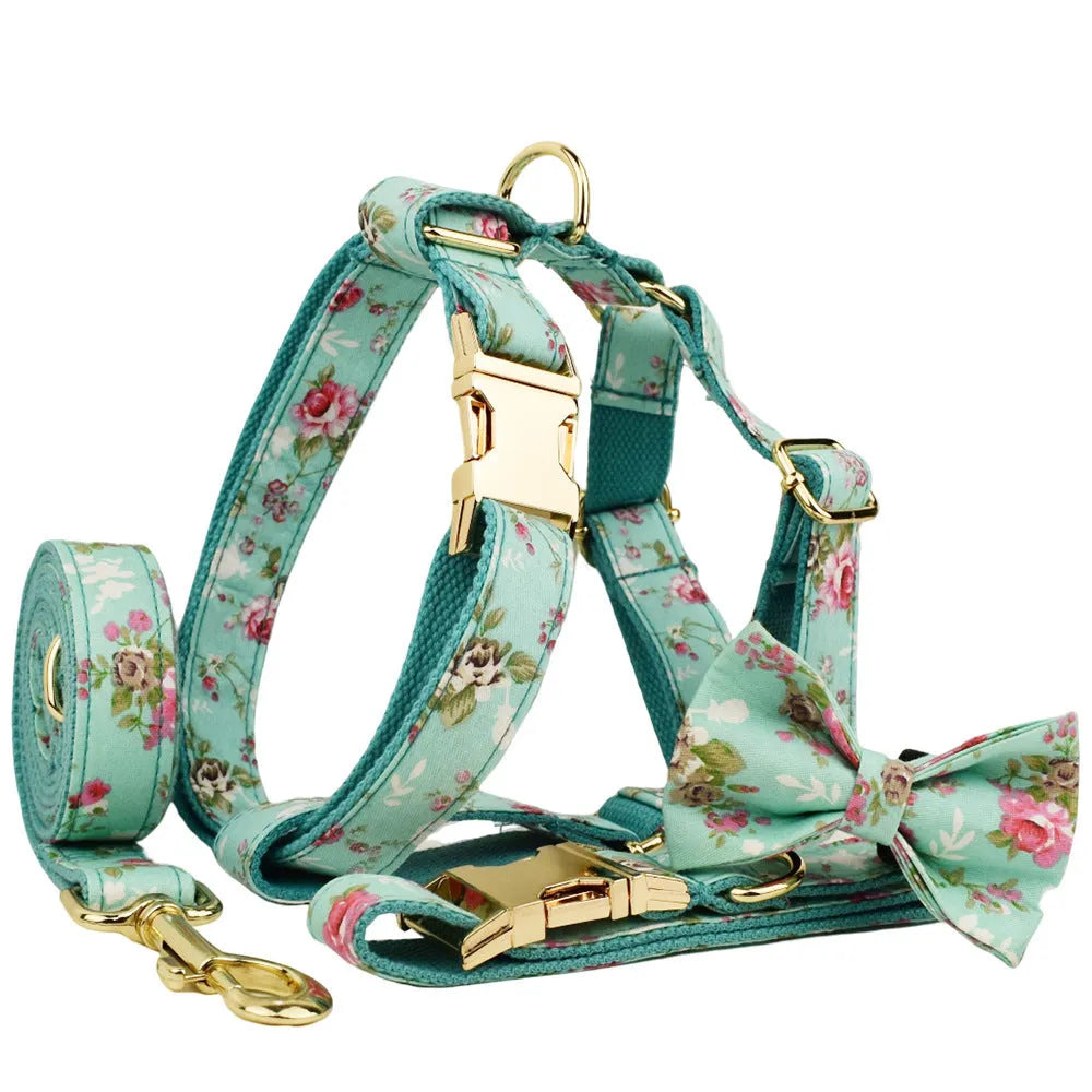 Rose print dog collar set with green background including collar, leash, detachable bow, and vest