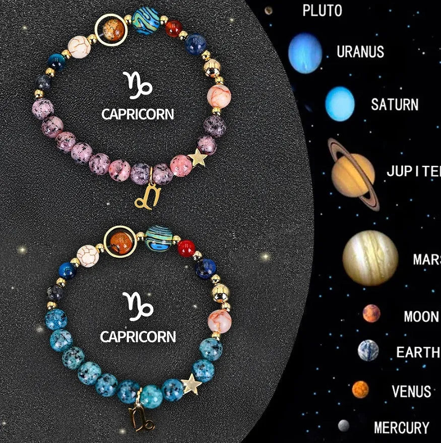 Two natural stone beaded bracelets with zodiac charms on a table.