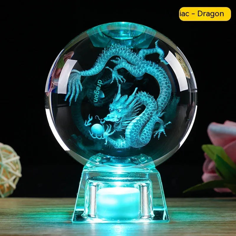 White crystal ball zodiac ornament with luminous electronic base showing Chinese animal designs