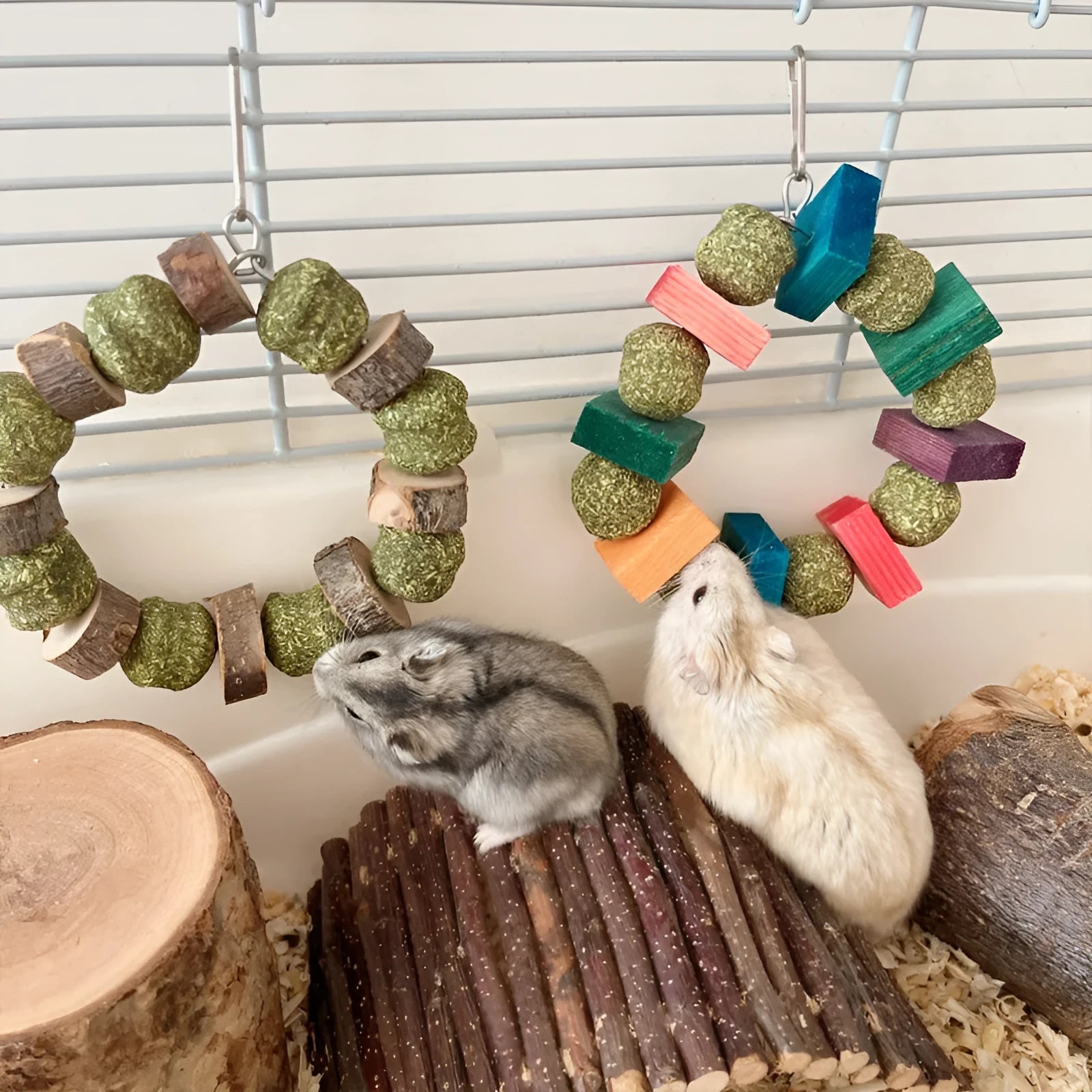 Hamster chew toy featuring applewood sticks and decorative straw balls with colourful sequins