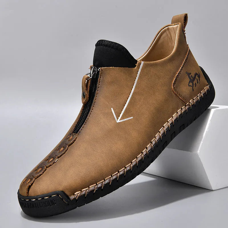 Men's black leather martin boots with a front zip, round toe, and hand-stitched seams on a rubber sole.