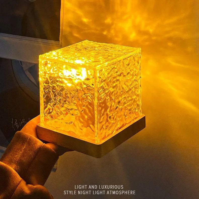 Geometric crystal LED table lamp projecting blue water ripple light patterns on wall with remote control