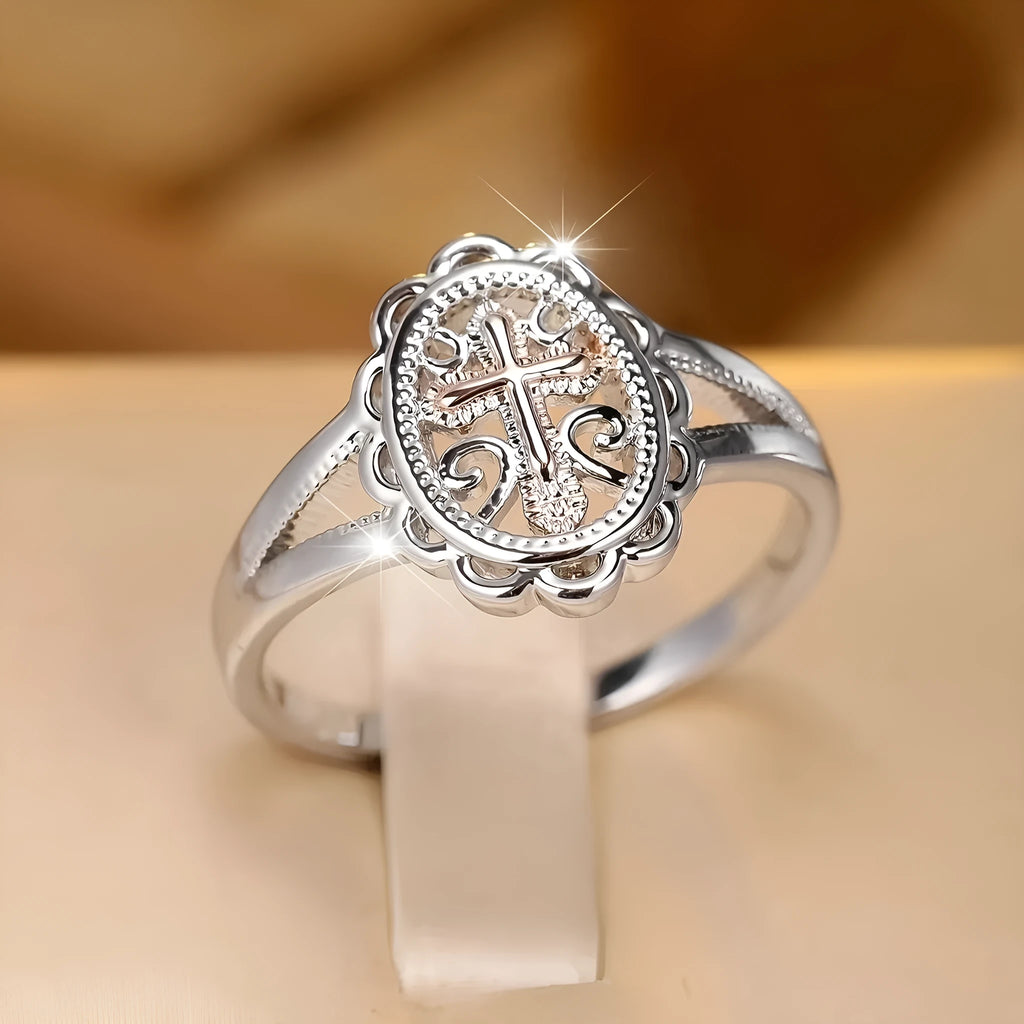 Silver electroplated alloy ring with detailed cross and lace design for women.