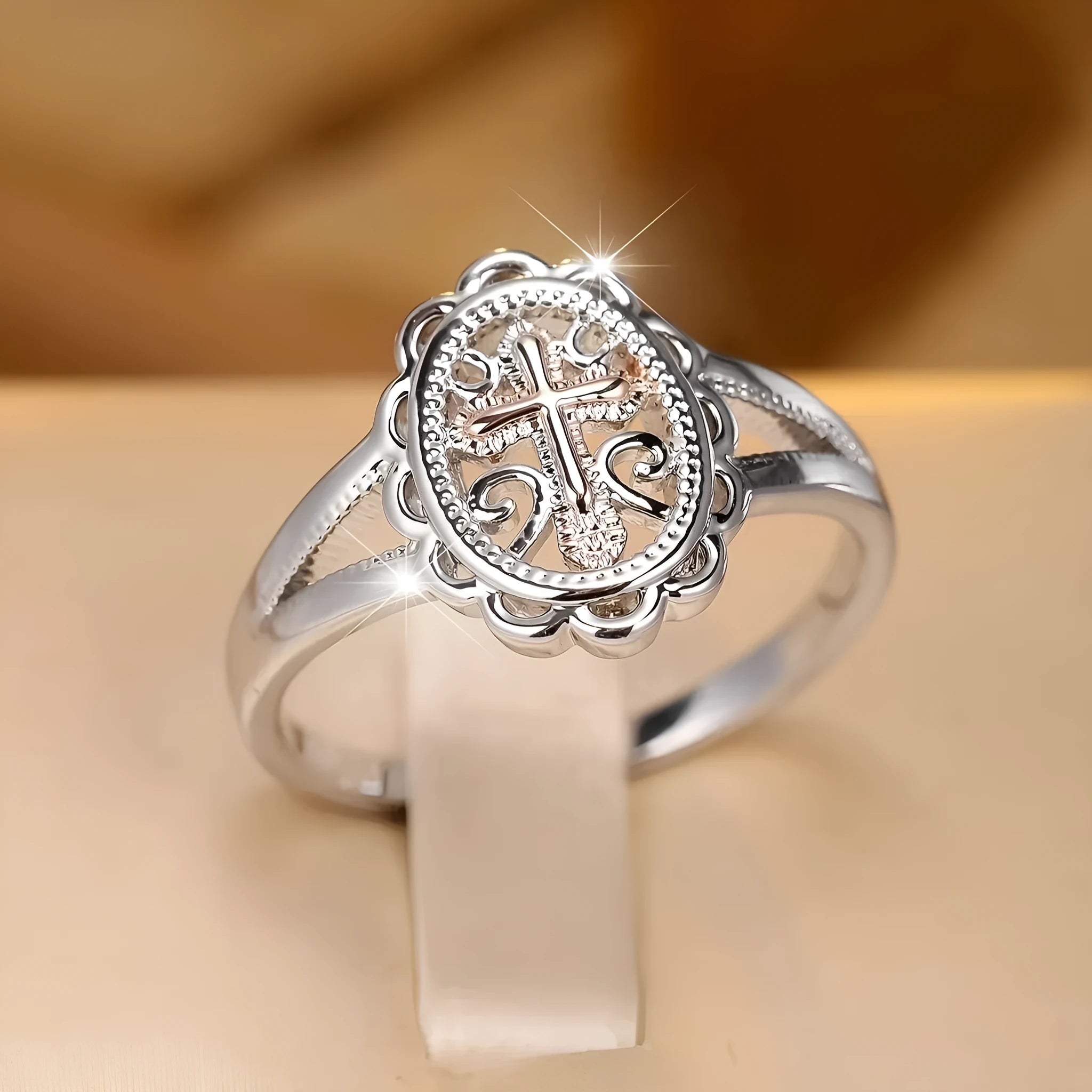 Silver electroplated alloy ring with detailed cross and lace design for women.