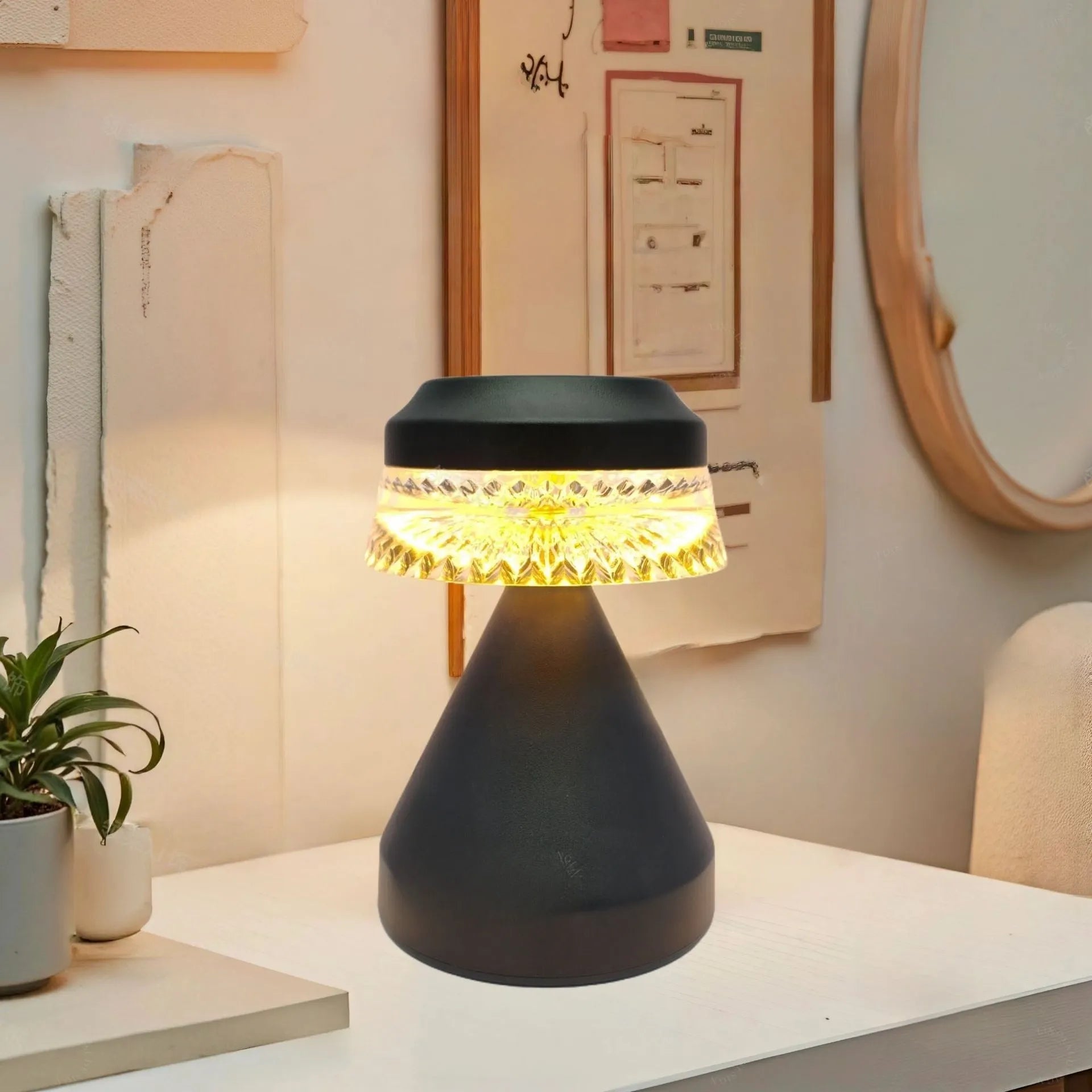 Small black bedside LED lamp with USB charging cable on wooden nightstand