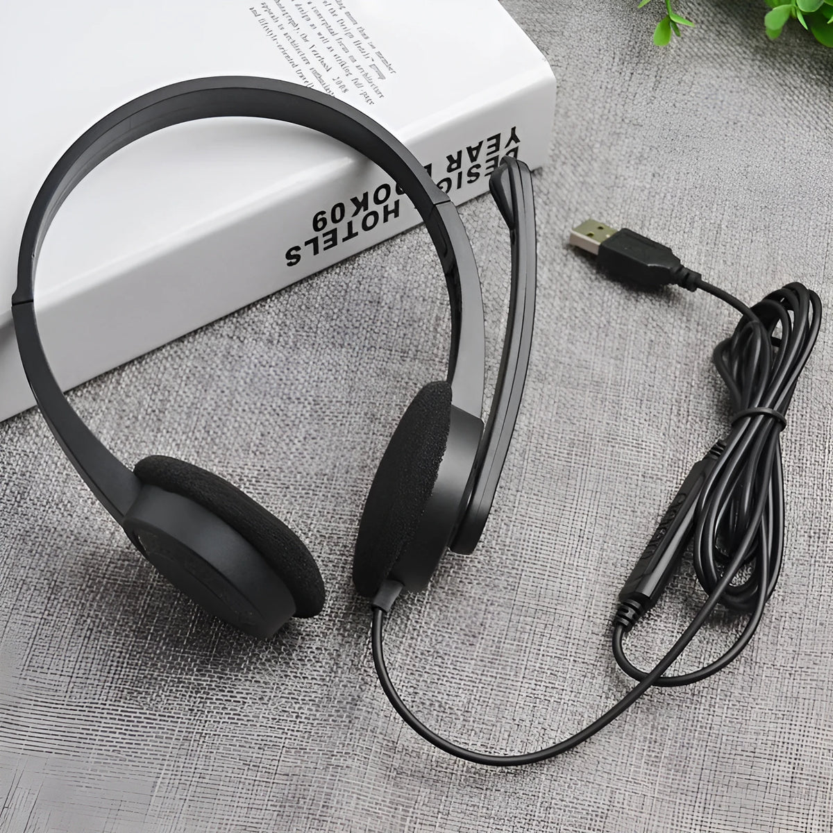 Black wired USB headset with sponge ear cushions and microphone for computer gaming and calls