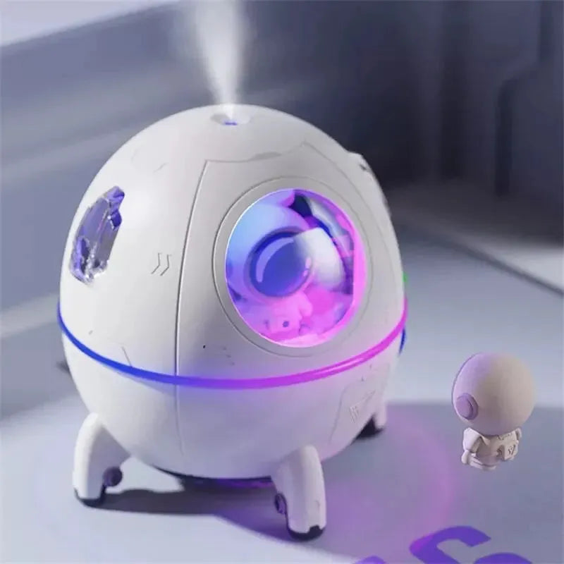Light purple astronaut-shaped USB desktop humidifier with LED light on a desk