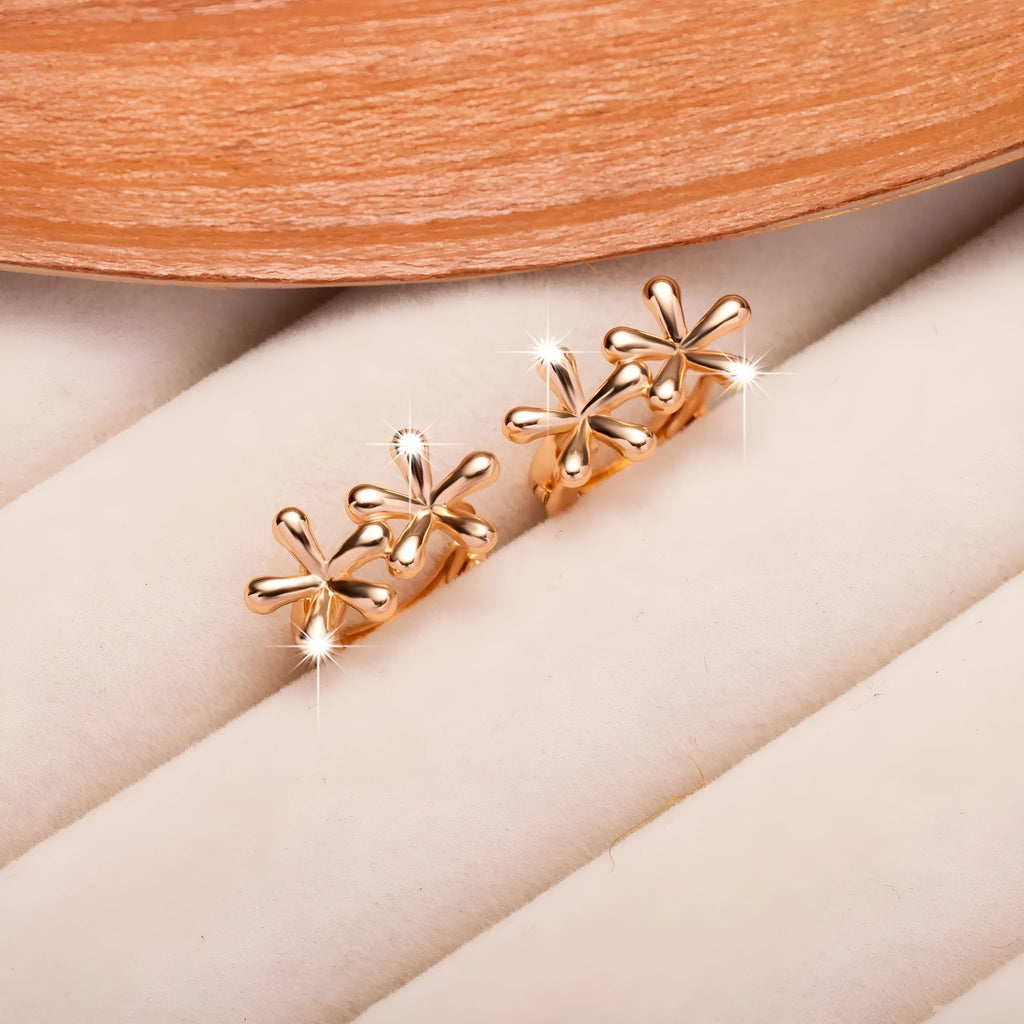 A pair of rose gold circular earrings featuring a waterdrop floral design with a fresh, sweet style.