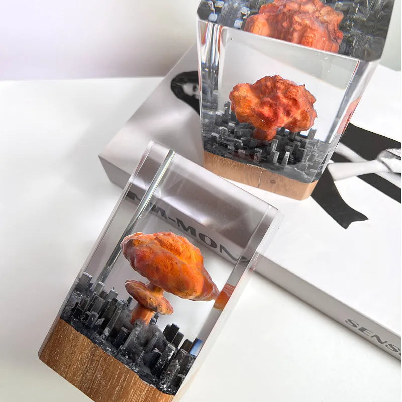 Small resin atomic bomb mushroom cloud night lamp ornament on a desk.