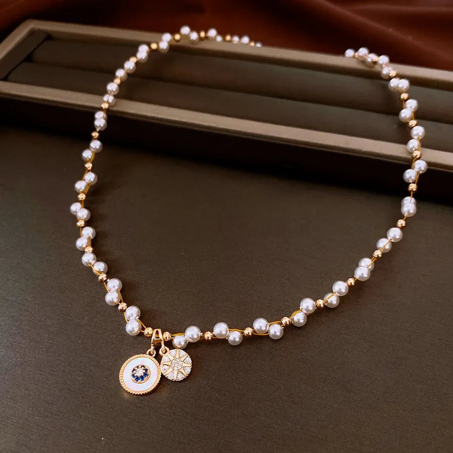 Gold electroplated zircon and imitation pearl pendant necklace on adjustable clavicle chain