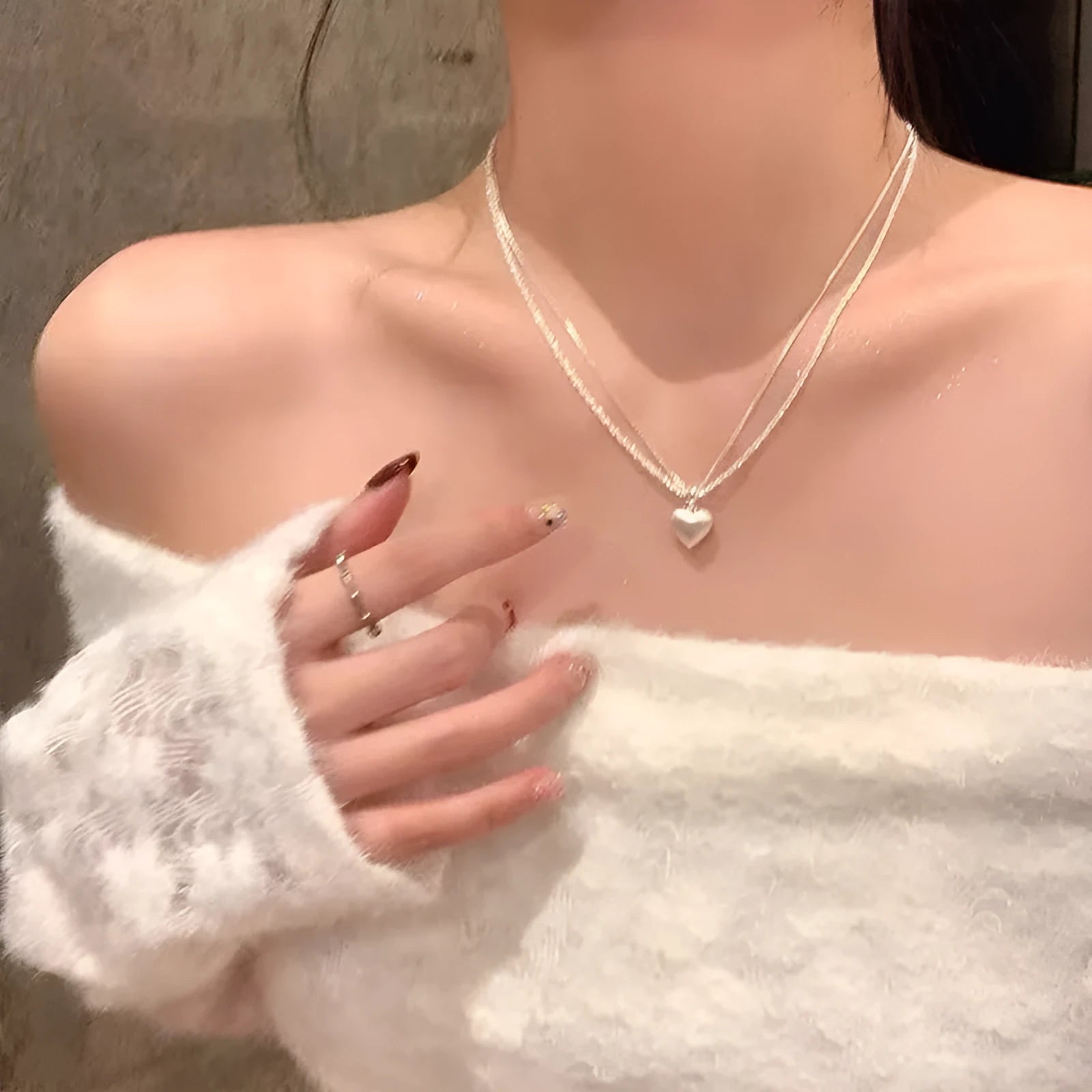 Double layer brushed heart shaped pendant necklace on adjustable silver tone chain.