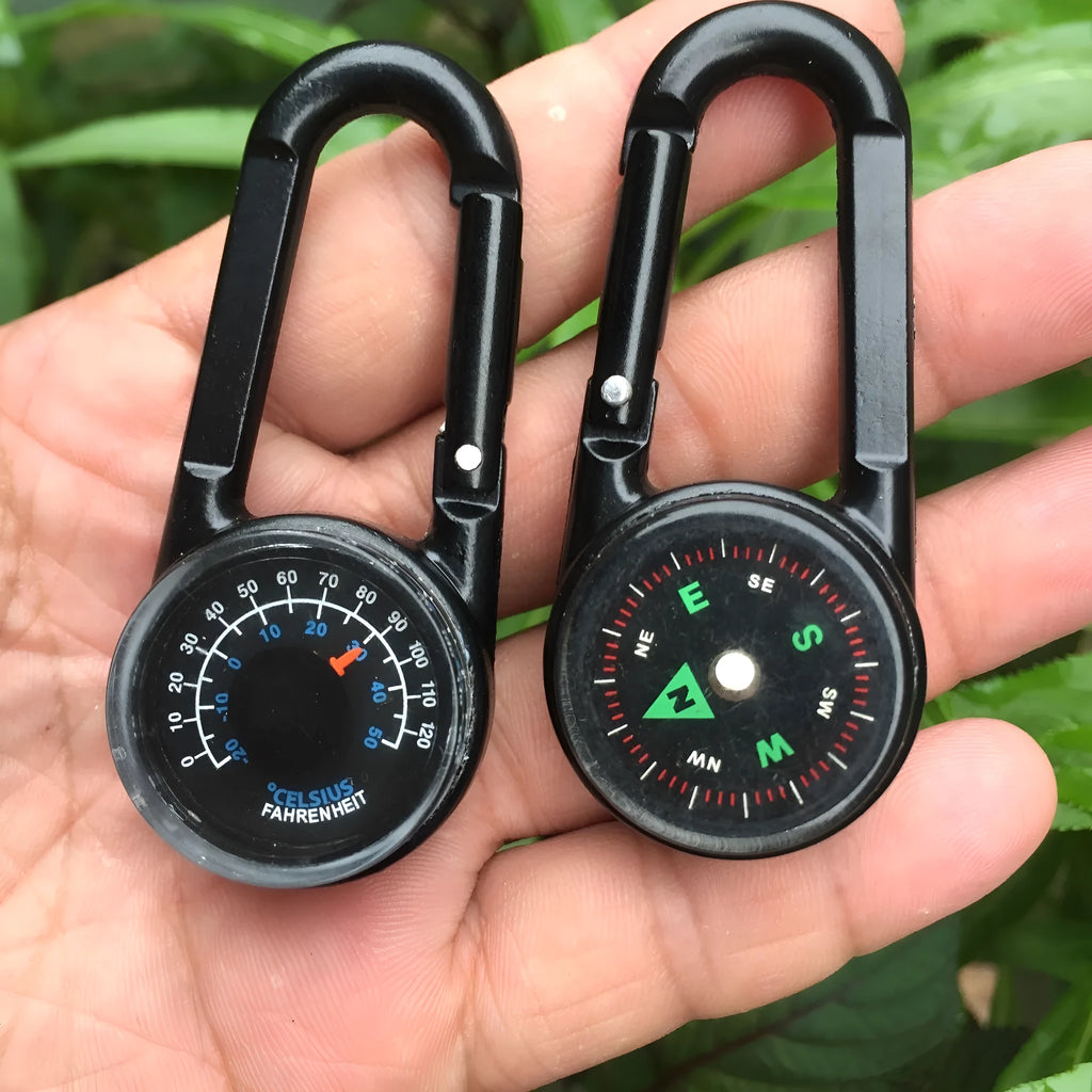 Army green zinc alloy outdoor carabiner with built-in fluid compass and liquid thermometer showing temperature scale