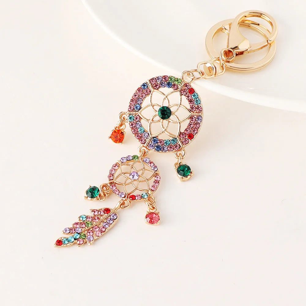 Creative diamond studded flower shaped car keychain dream catcher in pink alloy light luxury style on white background