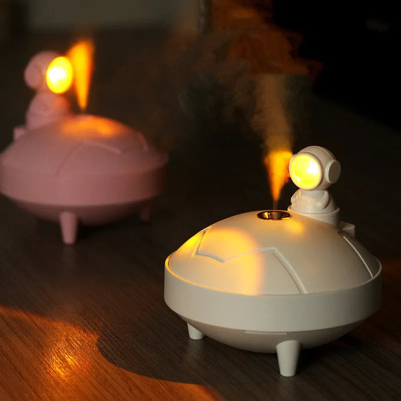 Astronaut sunset lamp humidifier with 360 degree rotating head in green colour, placed on a nightstand