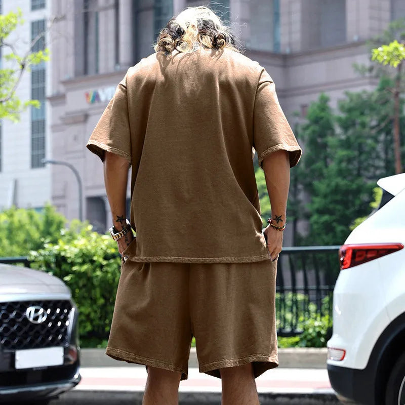 Men's casual sports suit set with grey round neck T-shirt and drawstring shorts on model