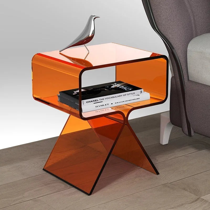 Minimalist acrylic side table in transparent black, 39x30x45cm, beside a sofa in a living room