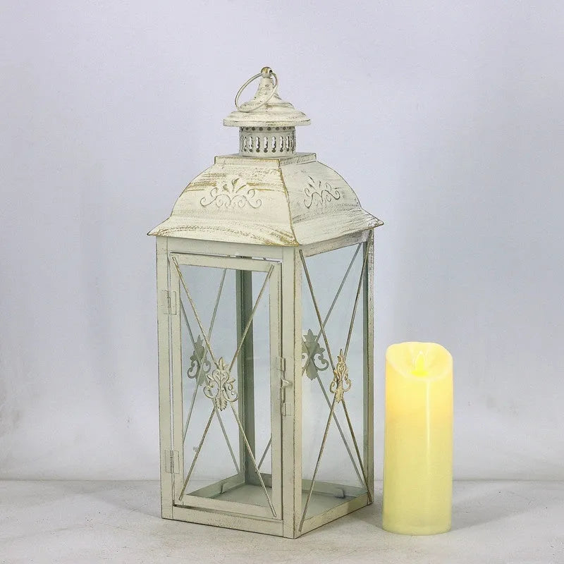 European wrought iron storm lantern with tempered glass in black or white gold finish, shown in small, medium, and large sizes.