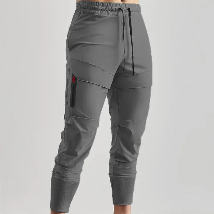Men's solid colour polyester jogger pants in black, mid-waist style, casual sports trousers