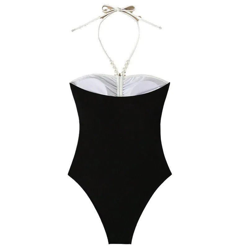 Black and white women's one-piece swimsuit with pearl spaghetti straps and slim-fitting design