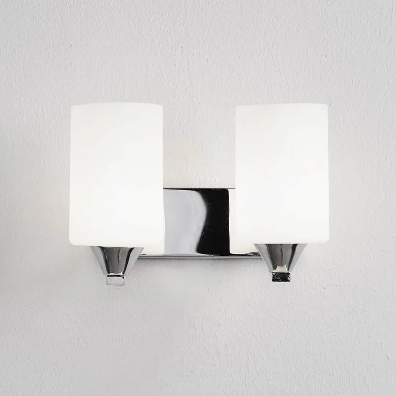Chrome-finished modern wall lamp with glass shade, shown in single head configuration.