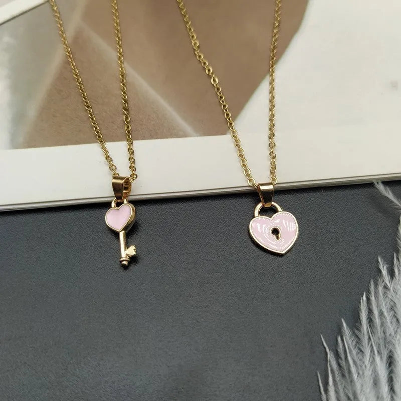 Small alloy lock and key pendant necklace set in black with 40cm chain on white background