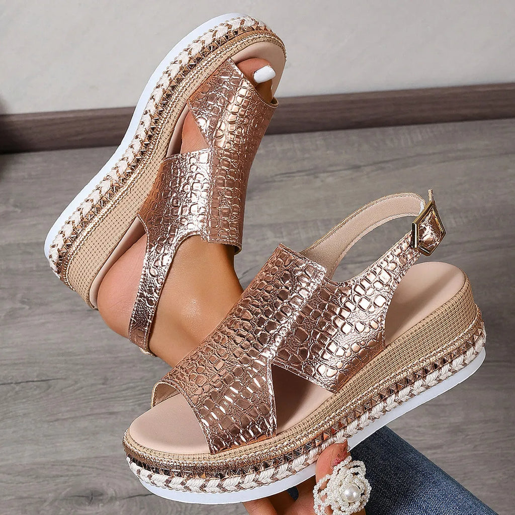 Gold Roman sandals with round toe, hollow-out design, and ankle buckle on rubber sole