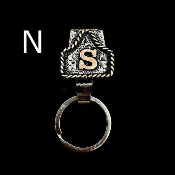 Handmade metal cow tag style key holder shown in one of its 26 colour options, attached to a keyring.