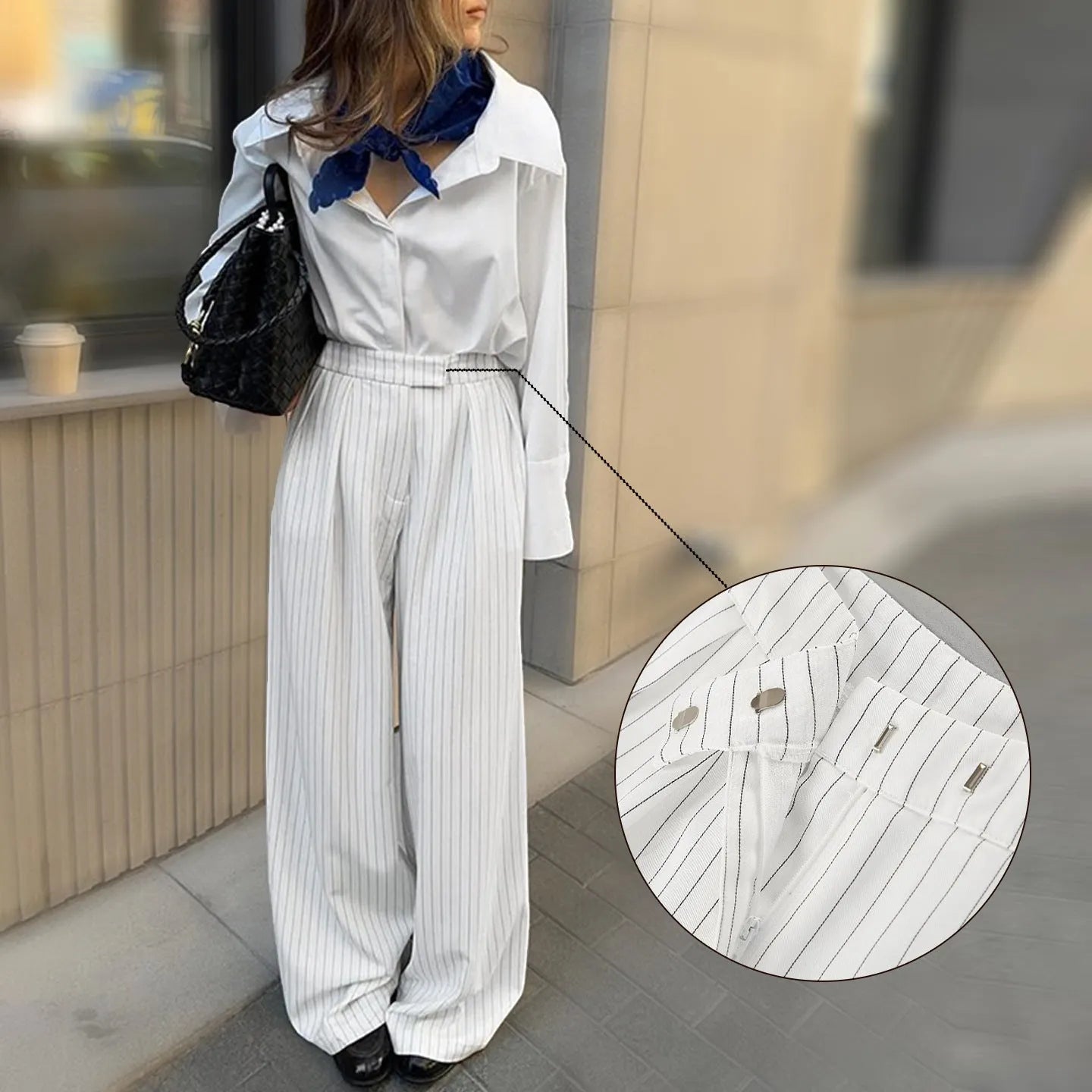 White striped wide-leg casual trousers with a zipper fastening on a neutral background.