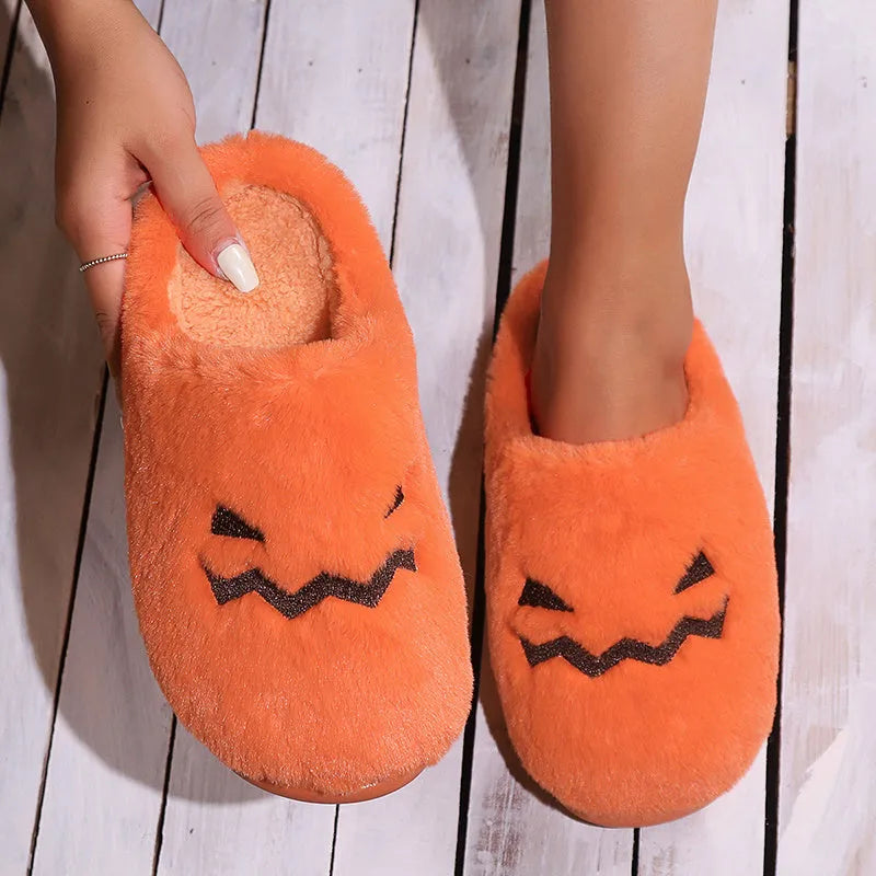 Orange pumpkin-shaped coral velvet plush slippers with a flat PVC sole.