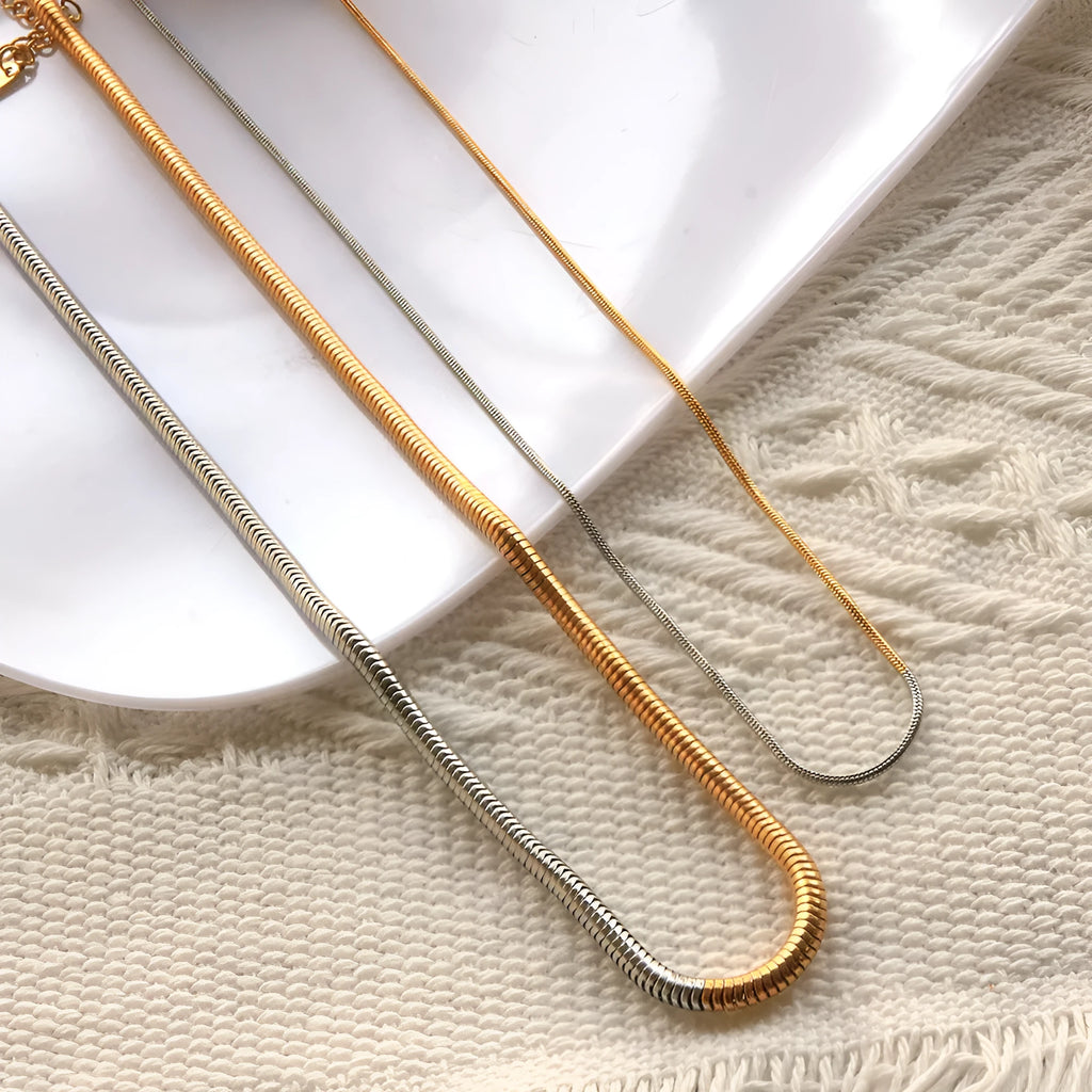 Gold-toned stainless steel snake bone chain necklace for women, 3mm wide.