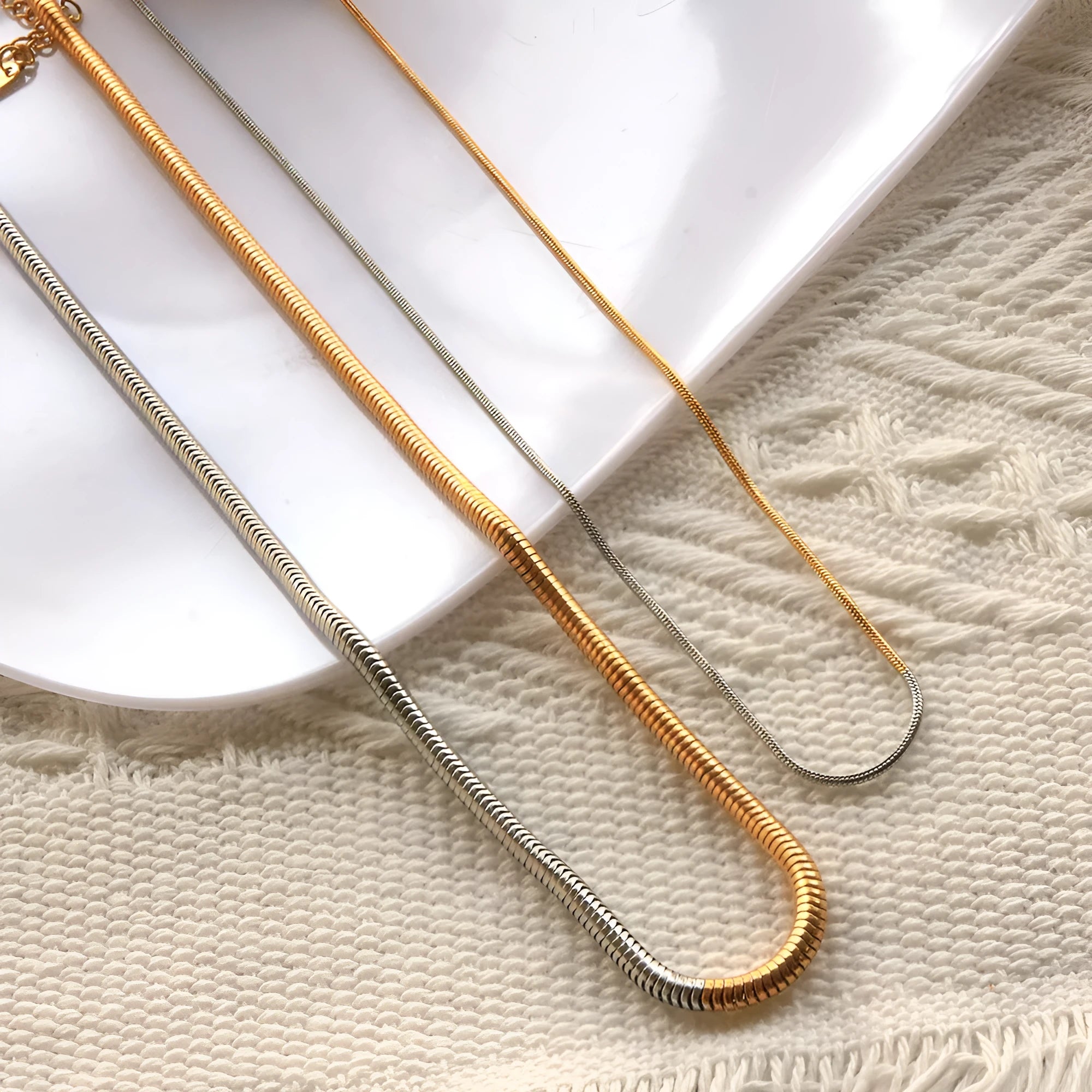 Gold-toned stainless steel snake bone chain necklace for women, 3mm wide.