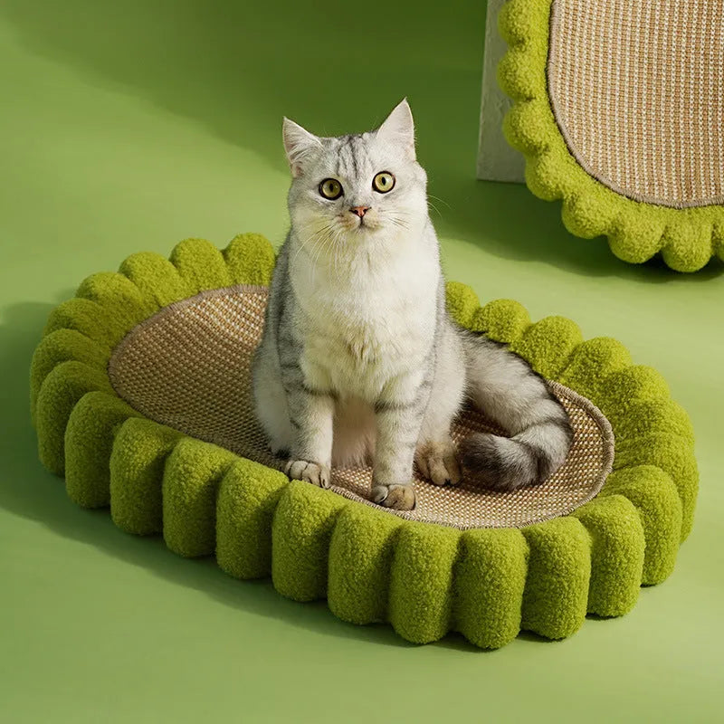 Green oval cat scratcher bed made of sisal, showing scratching surface and lounging area.