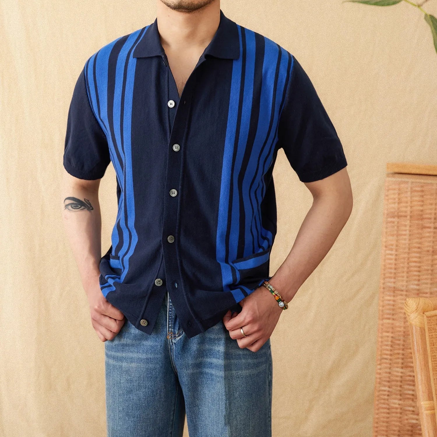 Cotton striped short sleeve knitted cardigan polo shirt on a hanger showing lapel collar.