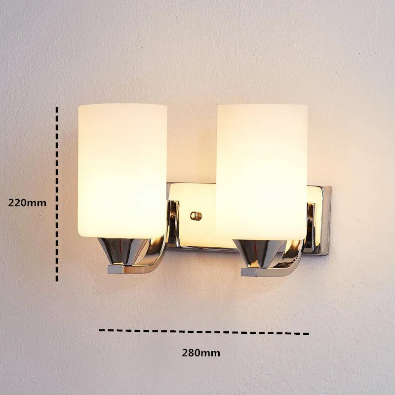 Chrome-finished modern wall lamp with glass shade, shown in single head configuration.