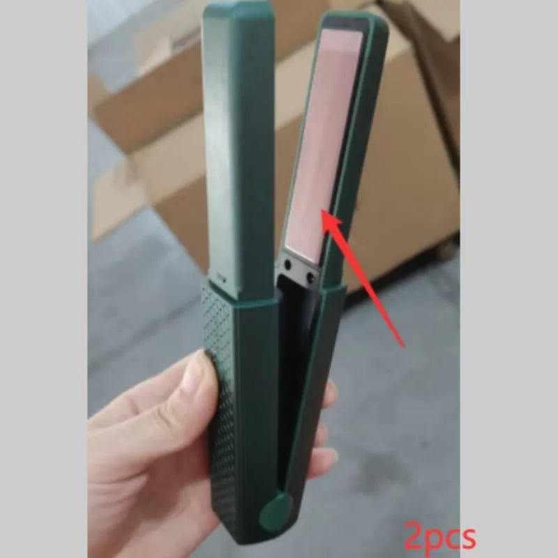 Pink and green mini cordless USB hair straightener with ceramic plates open on a white background.