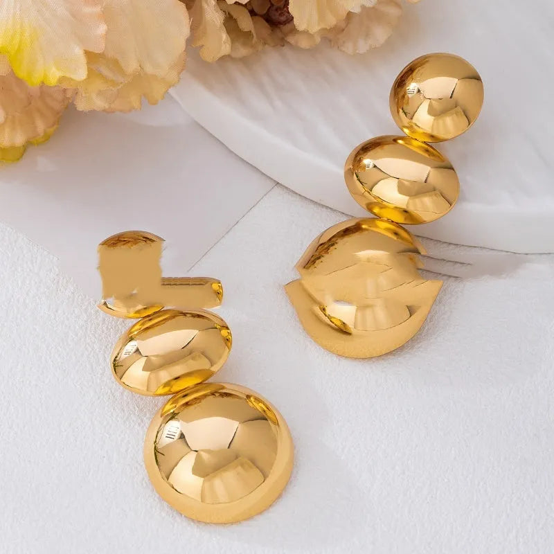 Retro women's polka dot metal bead drop earrings in frosted gold finish on a neutral background