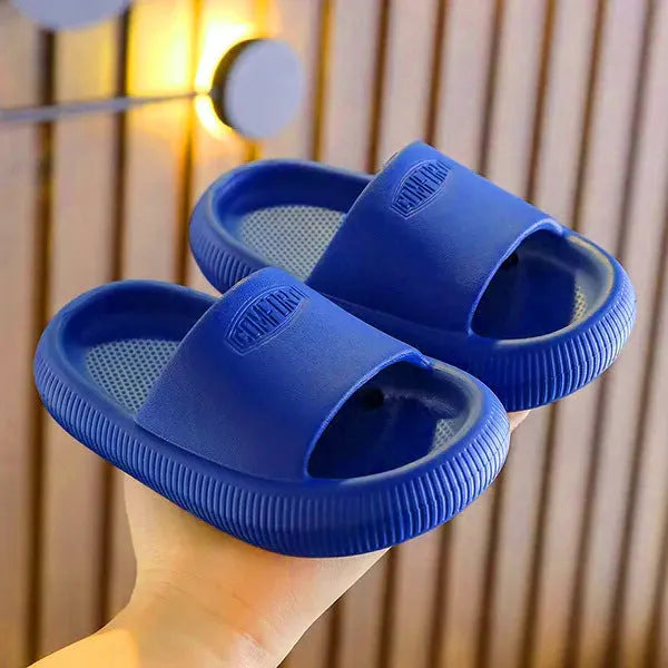 Colourful children's EVA slippers with a textured non-slip sole, shown in blue, green, orange, pink and yellow.