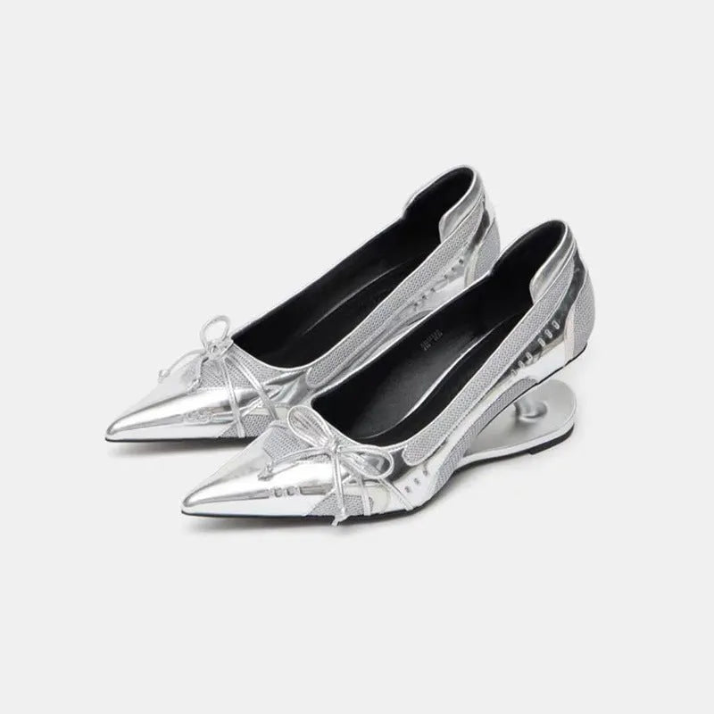 Women's black pointed toe Mary Jane shoes with a distinctive shaped floating heel and slip-on design.