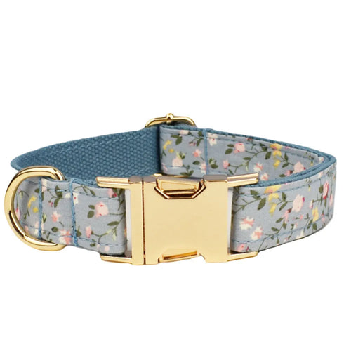 Blue floral patterned dog collar set with matching leash, bow, vest, and poop bag accessories
