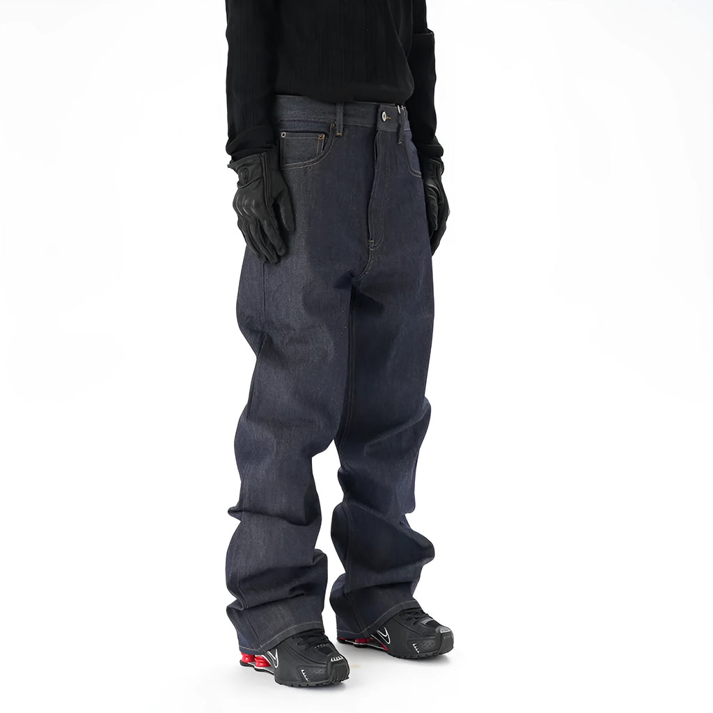 Man's dark blue loose-fit straight leg denim jeans on a neutral background.