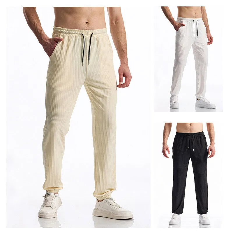 Men's black silky rib fabric casual trousers with baggy straight leg and elastic waistband