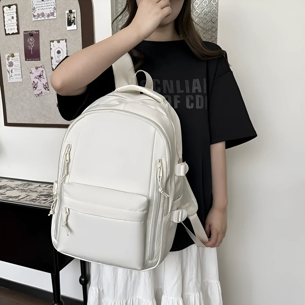 Women's large capacity solid colour schoolbag in black with curved shoulder strap and nylon material