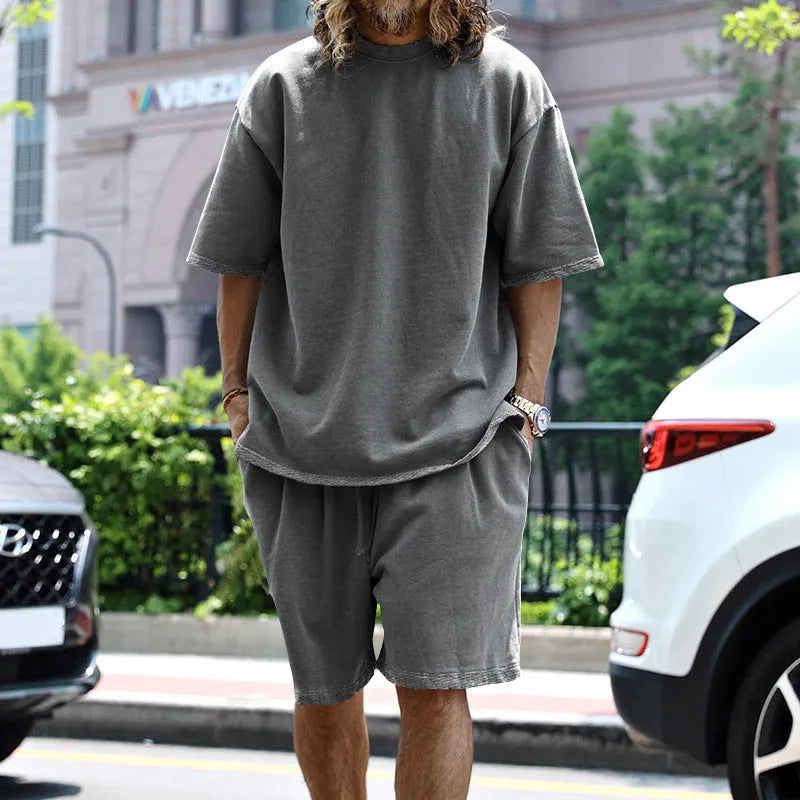 Men's casual sports suit set with grey round neck T-shirt and drawstring shorts on model