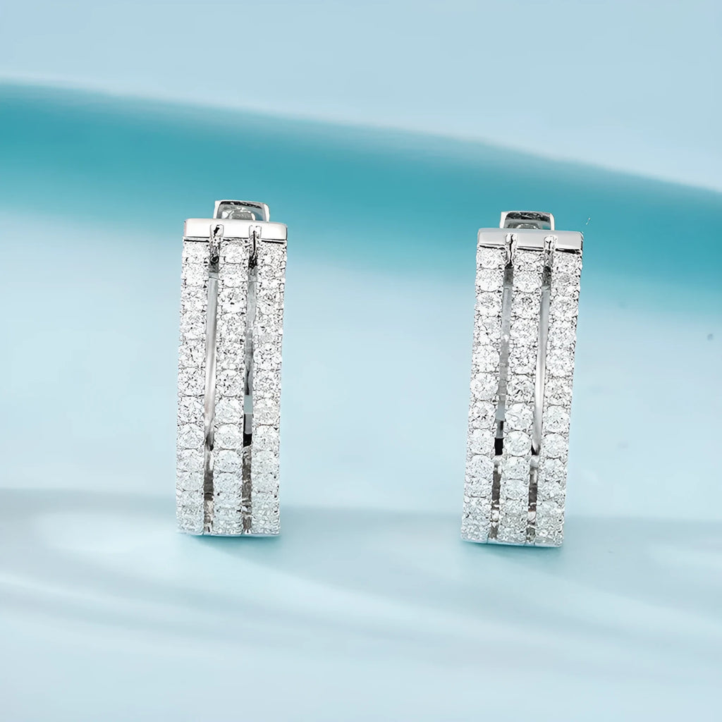 18K white gold natural diamond earrings with 56 point diamond in platinum finish on light background