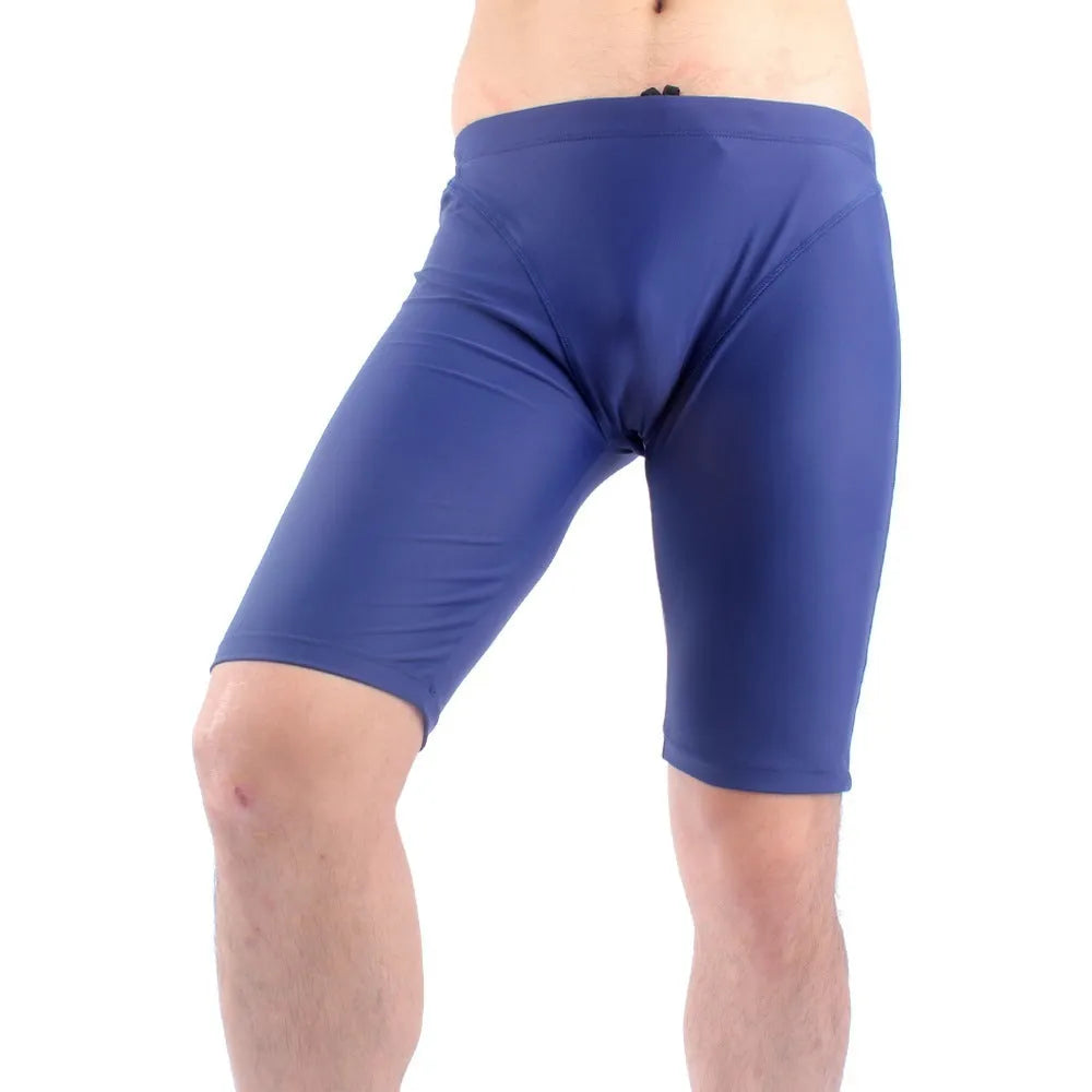 Green and navy blue men's loose-fit swimming trunks with a five-point design and polyester lining.