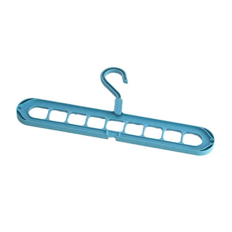 Green plastic nine-hole multifunctional clothes hanger for trousers on a white background.