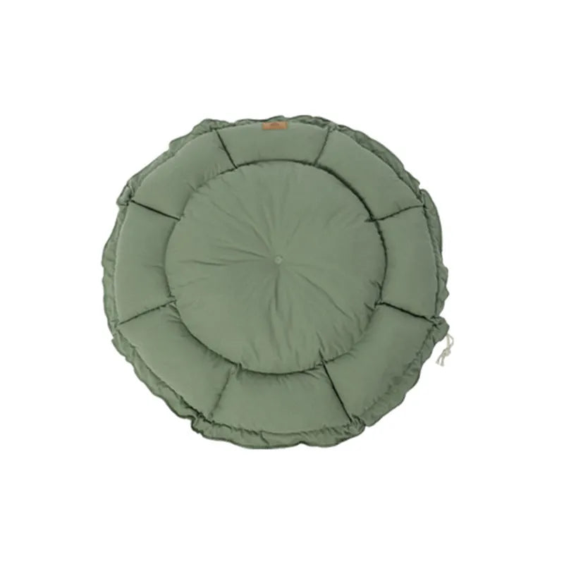 Grey and green reversible donut-shaped pet bed for cats and small dogs on a wooden floor.