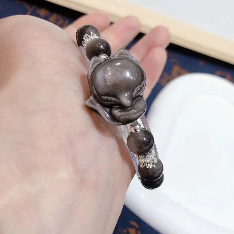 Natural silver stone big head fox bracelet with 8mm obsidian beads on a white background